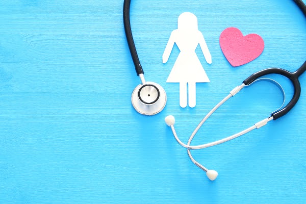 outline of woman and heart next to stethoscope on blue background